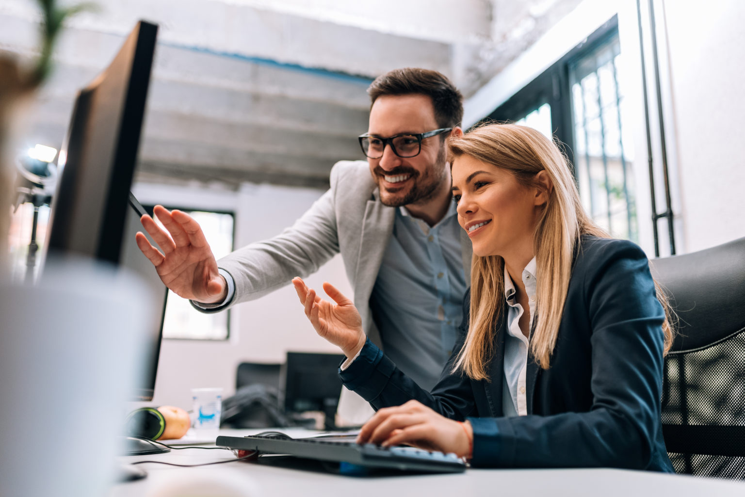 Image of two people looking at a computer