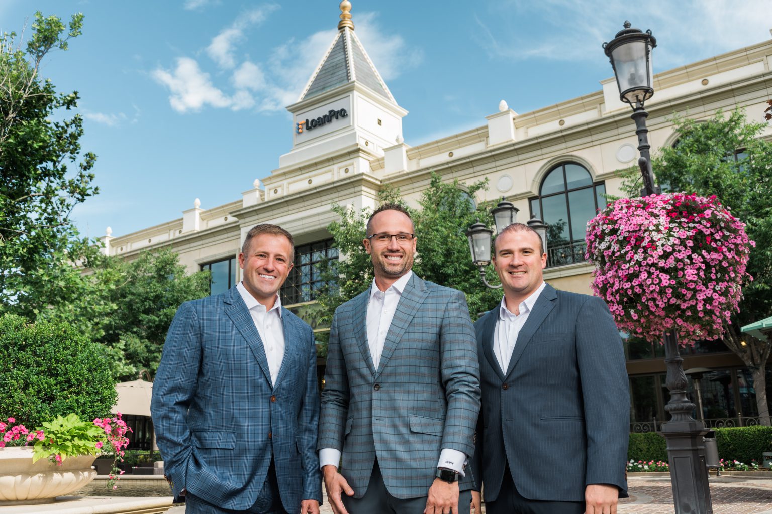 Image of the three founders of LoanPro in front of the headquarters